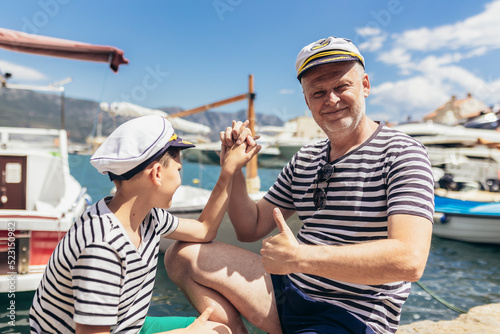 Father and son spending time at marina on summer day. © Mediteraneo
