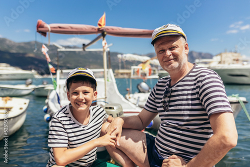 Father and son spending time at marina on summer day.