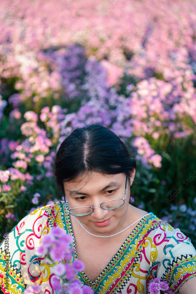 Woman (LGBTQ) posing at flower park garden field Woman (LGBTQ) posing at flower park garden field