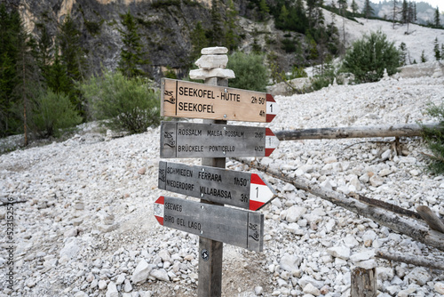 Alpine signpost of Seekofel, Rossalm, Schmieden ferrata, Seeweg in Dolomite mountains in the morning. Braies Lake (Pragser Wildsee, Lago di Braies), Dolomites, South Tirol, Italy, Europe. photo