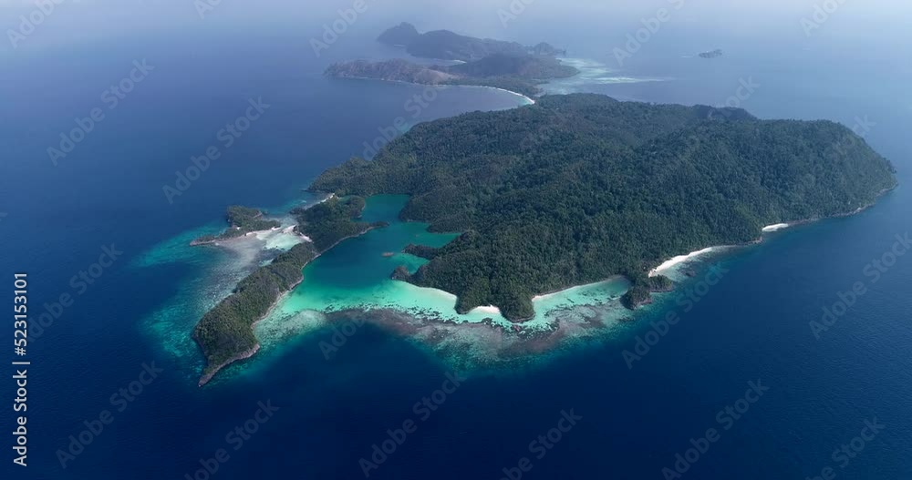 Aerial shot of tropical rocky island, turquoise water and white sand beach Aerial shot of tropical rocky island, turquoise water and white sand beach