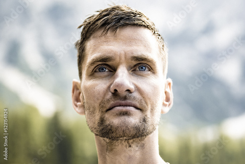 Young shirtless man with visionary view at Baires Lake in the Dolomite mountains in the afternoon. Braies Lake (Pragser Wildsee, Lago di Braies), Dolomites, South Tirol, Italy, Europe. photo