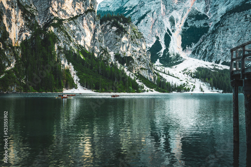 Panoramic view of Braies Lake with the hut and boats in Dolomites mountains and Seekofel in the afternoon. Braies Lake (Pragser Wildsee, Lago di Braies), Dolomites, South Tirol, Italy, Europe. photo