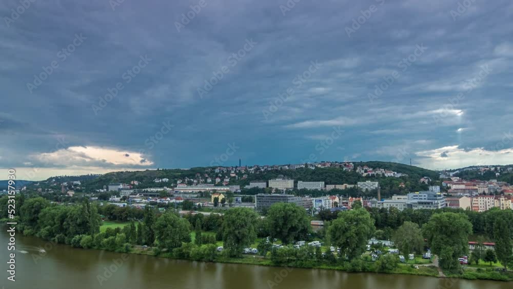 Aerial view of Prague timelapse from the observation deck of Visegrad. Prague. Czech Republic. Vltava river and green trees. Stormy weather with dark clouds Aerial view of Prague timelapse from the observation deck of Visegrad. Prague. Czech Republic. Vltava river and green trees. Stormy weather with dark clouds