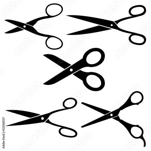 Different pairs of scissors on white background photo