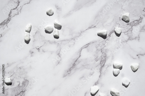 Photography Natural stone marble background with white stones