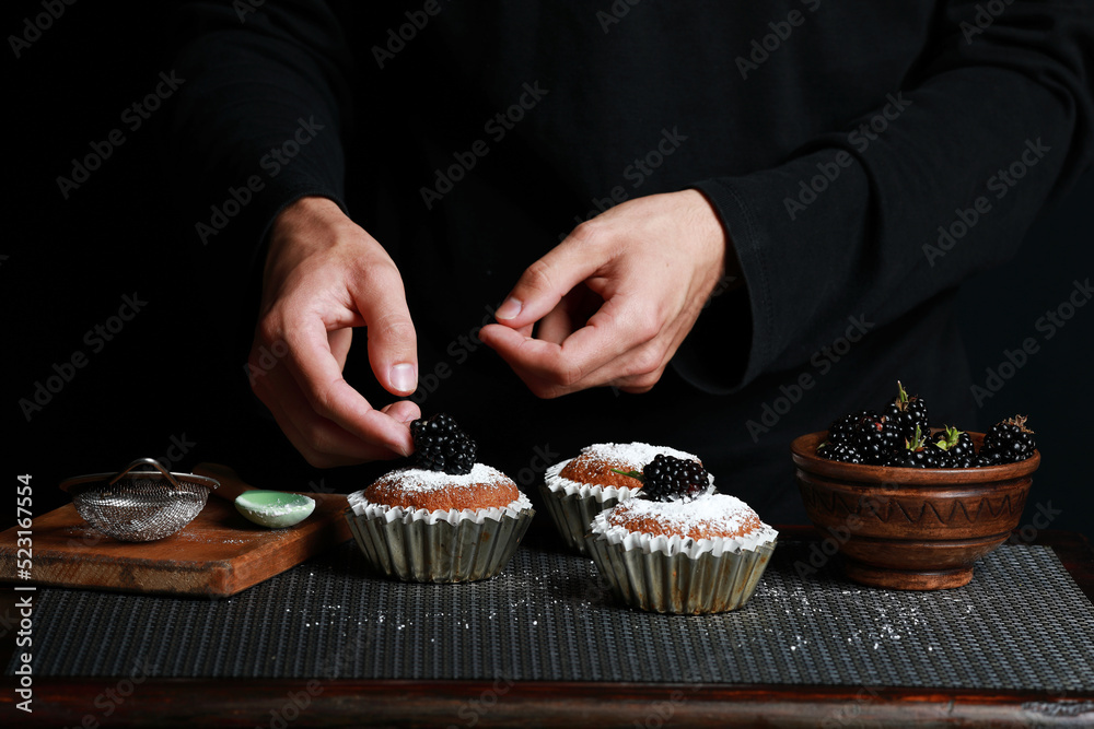 delicious cupcakes with blackberries and powdered sugar