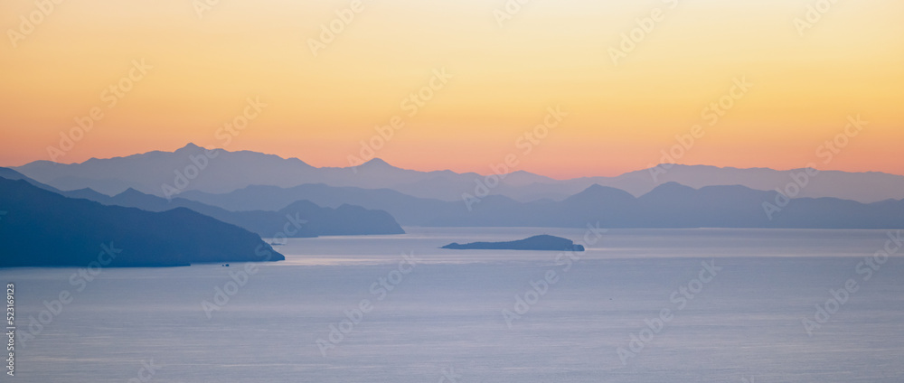 Summer scenery on the Mediterranean coast in Turkey near Marmaris and Icmeler. Just after dawn. A soft focus view of mountains in morning haze and blue water on Mediterranean sea