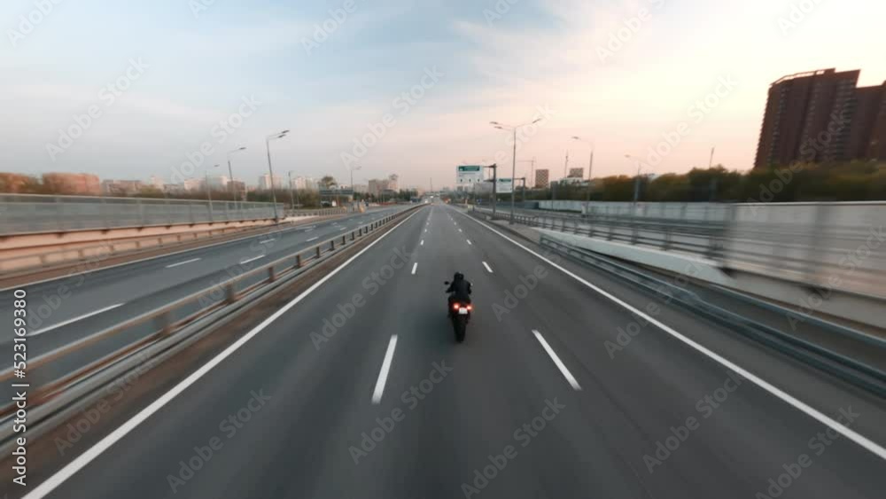 Fast BMW motorcycle rides city road under constructions filmed by fpv drone Fast BMW motorcycle rides city road under constructions filmed by fpv drone