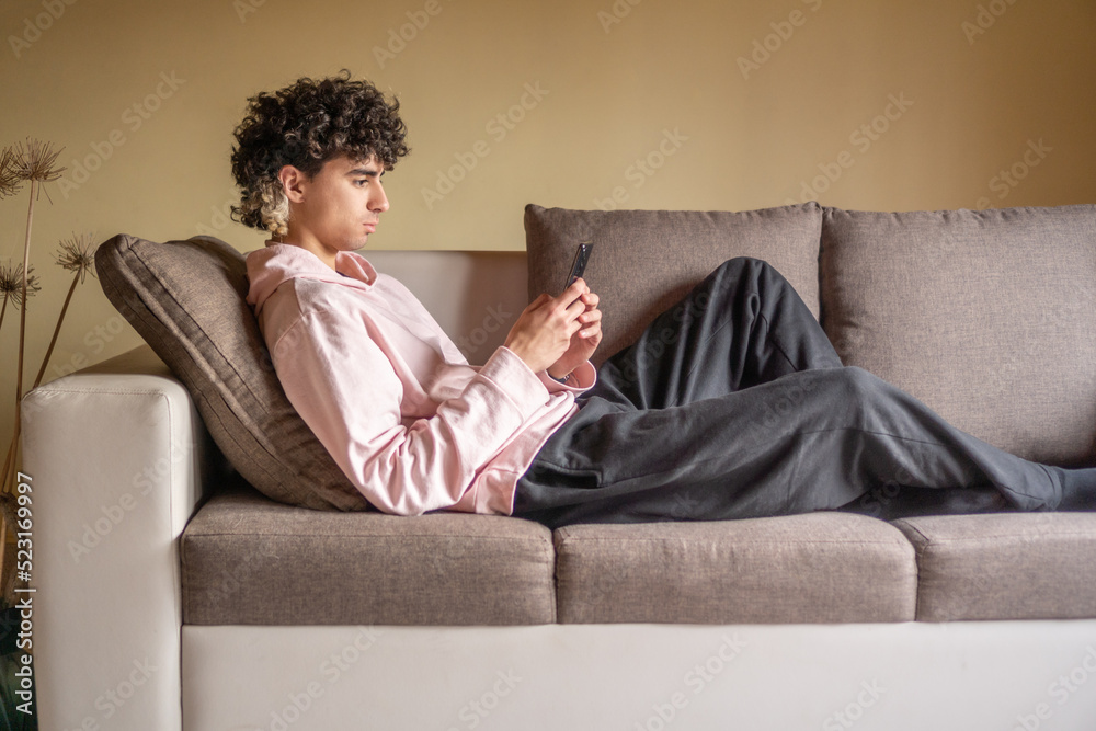 man with curls relaxing on sofa. man with curls relaxing on sofa.