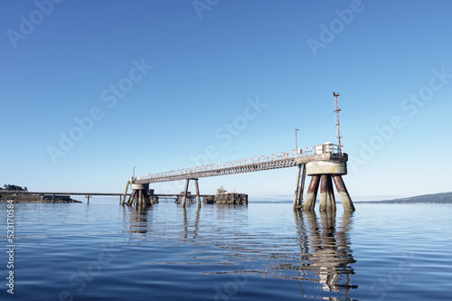 Old derelict wooden jetty pier in sea at Inverkip power station photo