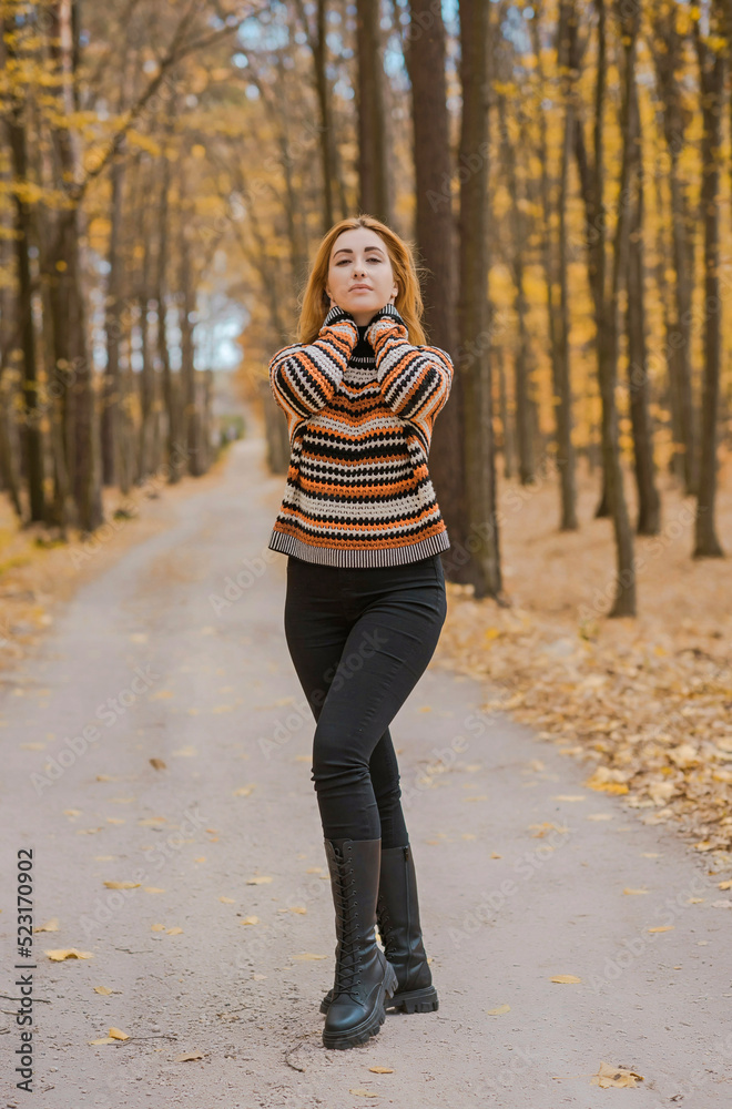 Autumn time, woman in warm clothes, new collection, black- orange sweater and dark outfit Autumn time, woman in warm clothes, new collection, black- orange sweater and dark outfit