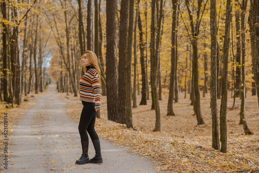 Autumn time, woman in warm clothes, new collection, black- orange sweater and dark outfit Autumn time, woman in warm clothes, new collection, black- orange sweater and dark outfit