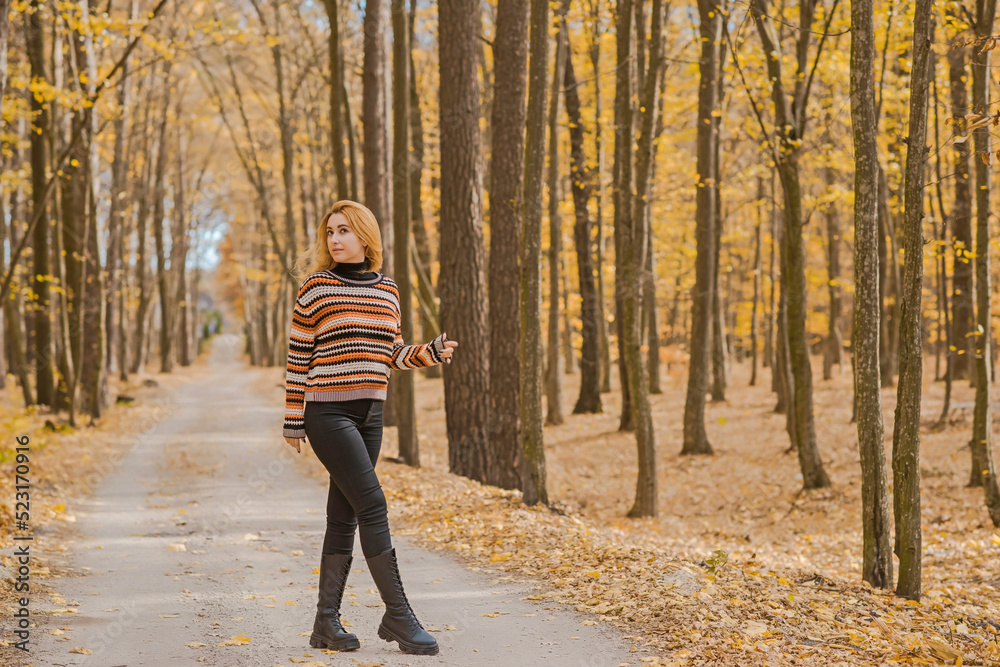 Autumn time, woman in warm clothes, new collection, black- orange sweater and dark outfit Autumn time, woman in warm clothes, new collection, black- orange sweater and dark outfit