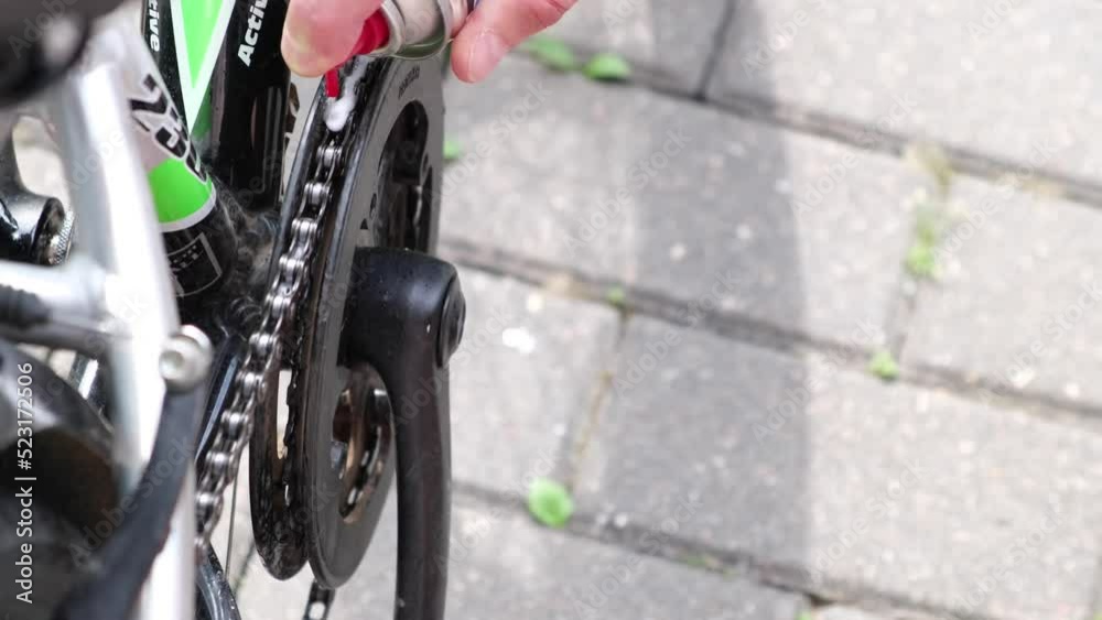 Applying oil on mountain bike chain. Man hands lubing bicycle chain. Technical expertise taking care Bicycle Shop. Lubing bike chain. Applying oil on mountain bike chain. Man hands lubing bicycle chain. Technical expertise taking care Bicycle Shop. Lubing bike chain.