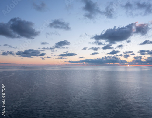 High angl view of the calm sunrise over the ocean with copy space