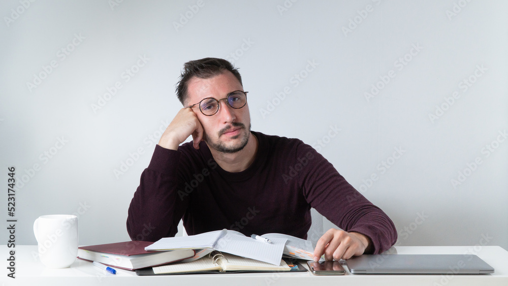 An office employee is bored in the workplace with a bunch of papers An office employee is bored in the workplace with a bunch of papers