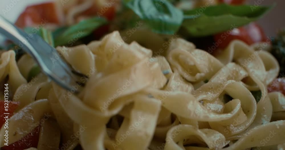 A European woman is sitting in a cafe, eating pasta and looking out the window. The concept of modern urban life. A European woman is sitting in a cafe, eating pasta and looking out the window. The concept of modern urban life.
