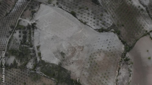 Aerial Drone view of Green Fields, Hills and Trees in a with Small Houses. Turkey.