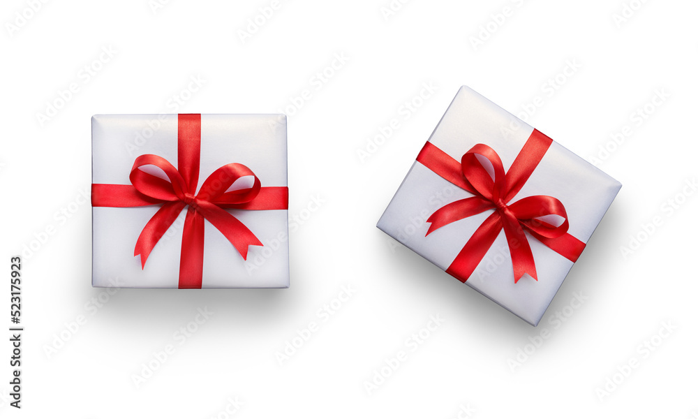 Top view of Christmas, birthday presents wrapped in white paper with red ribbon and bow decoration isolated against a transparent background.