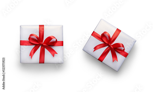 Obraz na płótnie Top view of Christmas, birthday presents wrapped in white paper with red ribbon and bow decoration isolated against a transparent background. w salonie