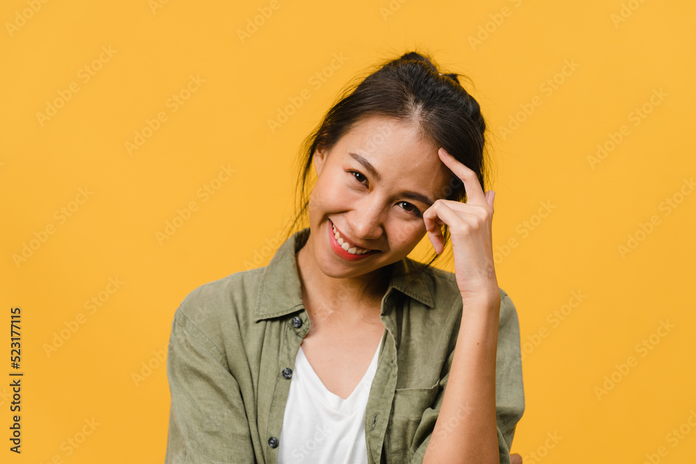 Young Asia lady with positive expression, smile broadly, dressed in casual clothing and looking at camera over yellow background. Happy adorable glad woman rejoices success. Facial expression concept.