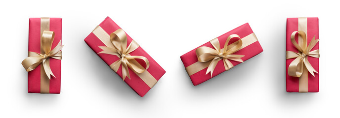 Top view of Christmas presents wrapped in red paper with gold ribbon and bow decoration isolated against a transparent background.