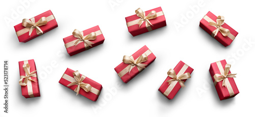Obraz na płótnie Top view of Christmas presents wrapped in red paper with gold ribbon and bow decoration isolated against a transparent background. w salonie