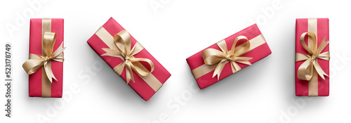 Obraz na płótnie Top view of Christmas presents wrapped in red paper with gold ribbon and bow decoration isolated against a transparent background. w salonie