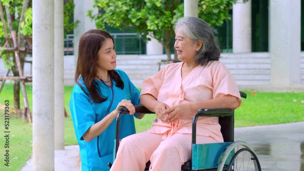 Asian careful caregiver or nurse taking care of the elderly Asian patient in a wheelchair. Concept of happy retirement with care from a caregiver and Savings and senior health insurance. elderly care Asian careful caregiver or nurse taking care of the elderly Asian patient in a wheelchair. Concept of happy retirement with care from a caregiver and Savings and senior health insurance. elderly care