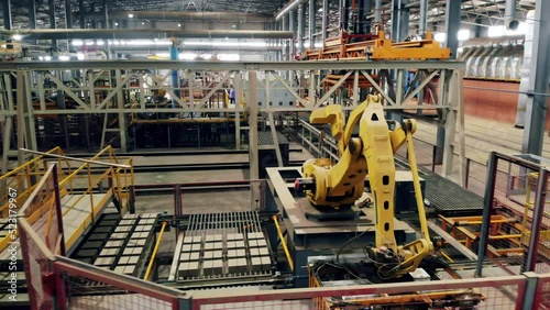 Robotized complex, robot manipulator worling at modern factory. photo