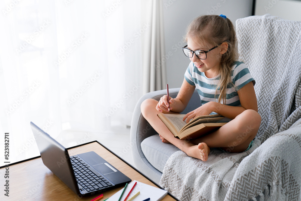 Distance learning at home. School child using laptop for online education in virtual class. Kid talking on video call at lesson. Homeschooling, remote connection, communication, technology lifestyle Distance learning at home. School child using laptop for online education in virtual class. Kid talking on video call at lesson. Homeschooling, remote connection, communication, technology lifestyle