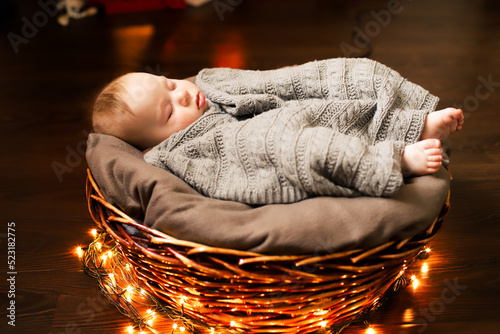 a baby under the tree. the family celebrates Christmas.