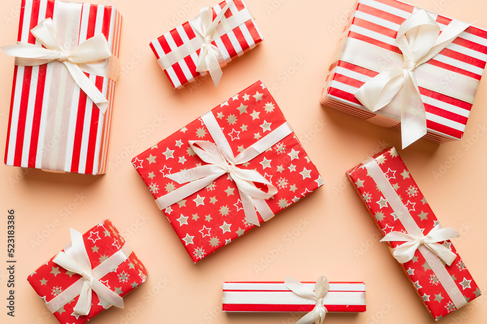 Fototapeta premium A lot of Christmas gift boxes in colored paper decorated on table, Top view close up. Many present New Year gift