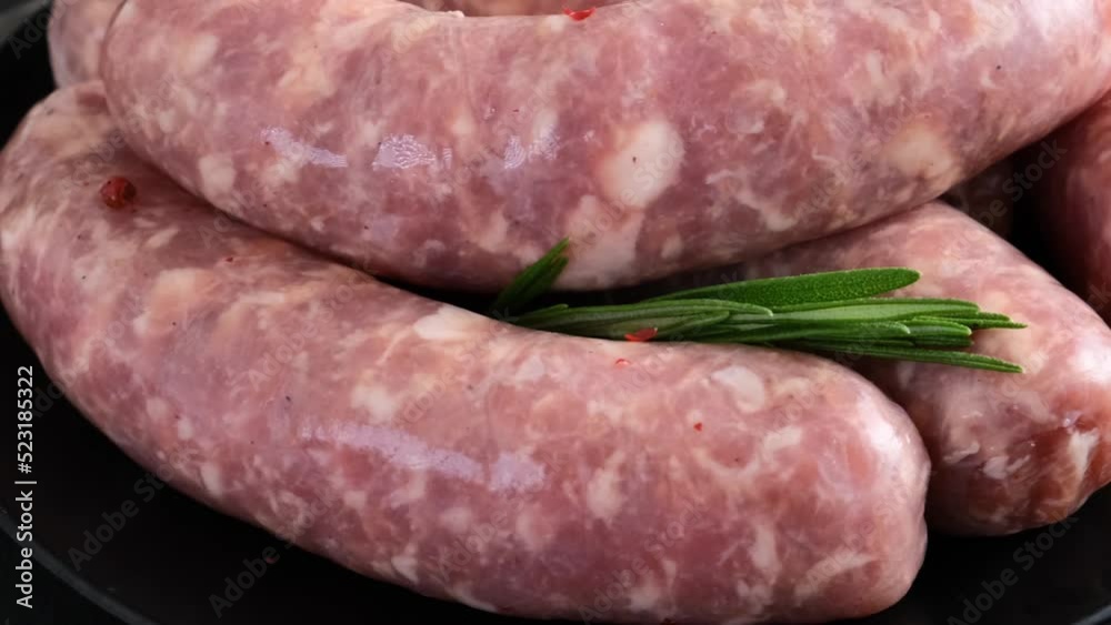 Raw pork sausages or bratwurst for grill or barbecue ready for cooking on Oktoberfest. Close up. 4k video Raw pork sausages or bratwurst for grill or barbecue ready for cooking on Oktoberfest. Close up. 4k video