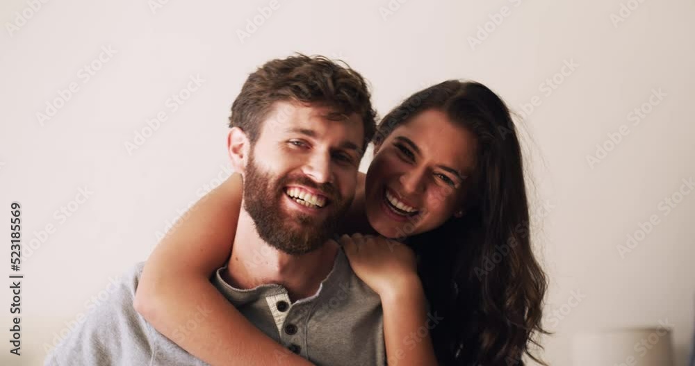 Caring, loving and happy couple hugging and bonding in a living room at home. Smiling young husband and wife holding each other and embracing. Happy playful man and woman laughing and feeling in love Caring, loving and happy couple hugging and bonding in a living room at home. Smiling young husband and wife holding each other and embracing. Happy playful man and woman laughing and feeling in love