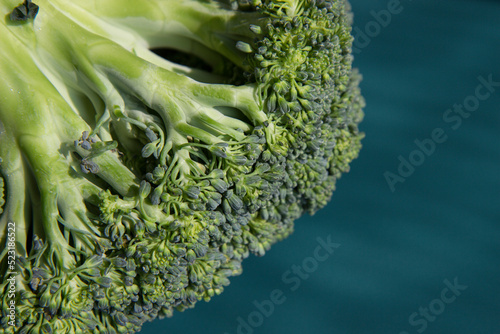 Fresh broccoli on a dark green background close-up.