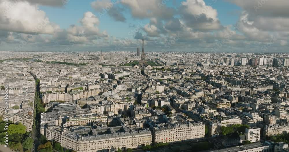 Aerial drone distant sunset view of Tour Eiffel Tower and Seine River bridge traffic cars driving, Paris city attractions, France