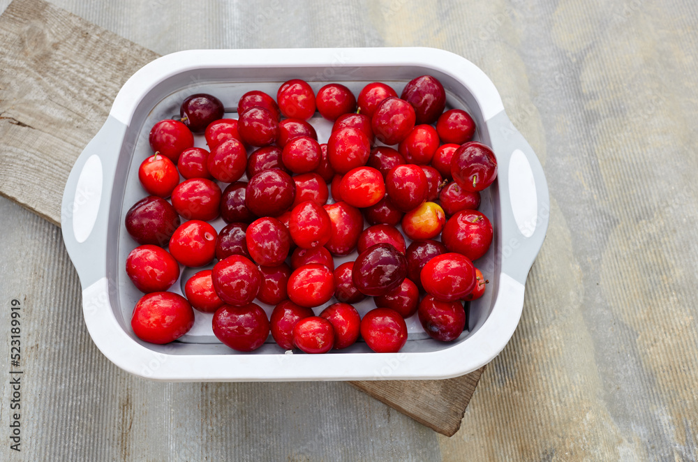 Ripe red cherry plums on plate. Juicy fruit on wooden background, closeup. Fresh plum, vegetarian food Ripe red cherry plums on plate. Juicy fruit on wooden background, closeup. Fresh plum, vegetarian food