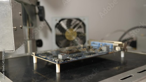 When repairing a motherboard, the chip is unsoldered at a soldering station. Repair and maintenance of computers. photo