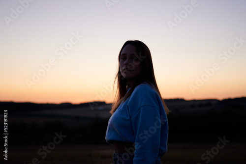A view of female in a backlighting against a the sunset