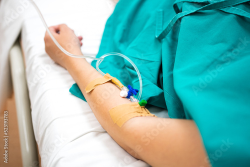 Close up view of a female hand with a dropper for intravenous injection