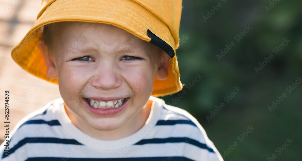 A little boy is crying from pain, grief and resentment. Children's crisis and tears. The whims of a small child. Hysterics and crying. A little boy is crying from pain, grief and resentment. Children's crisis and tears. The whims of a small child. Hysterics and crying.