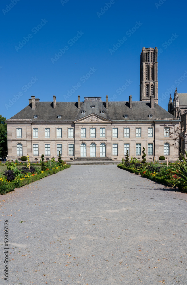 a large french style period building under a clear blue sky