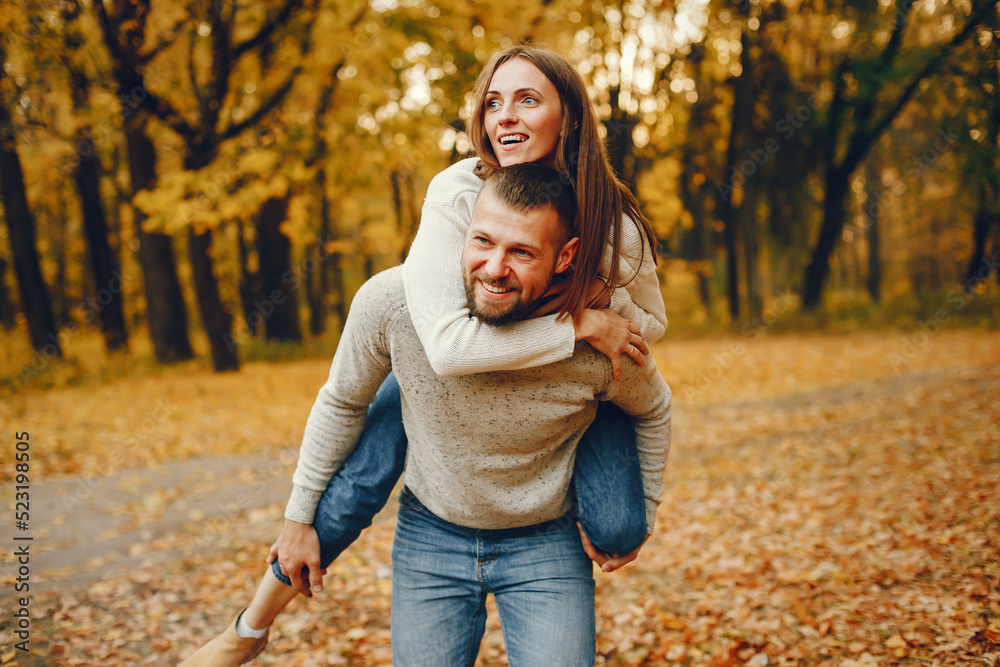Elegant couple spend time in a autumn park Elegant couple spend time in a autumn park