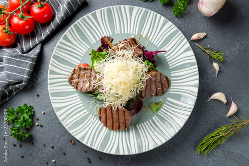 Steak salad with beef, mix salad and cheese on grey table top view
