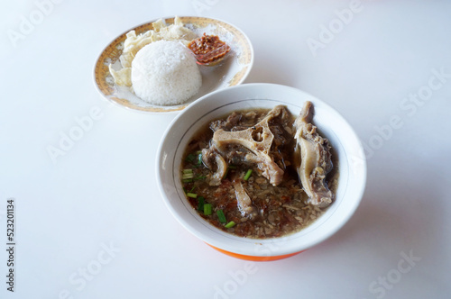 Indonesian tradisional soup called sop buntut with rice and emping melinjo with selective focus      photo
