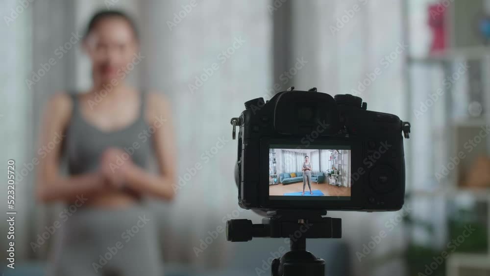 Close Up Of A Camera Monitor Recording Asian Trainer Female In Sports Clothes Speaking And Doing Cardio High Knees While Teaching Exercise At Home
Close Up Of A Camera Monitor Recording Asian Trainer Female In Sports Clothes Speaking And Doing Cardio High Knees While Teaching Exercise At Home