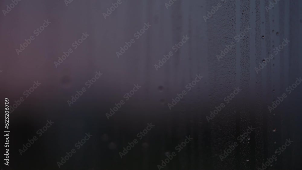 Water drops on window glass with sunset light Water drops on window glass with sunset light