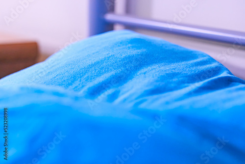 Dorm room bunk bed closeup blue sheets